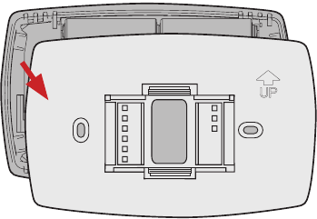 Separe la placa de pared del nuevo termostato