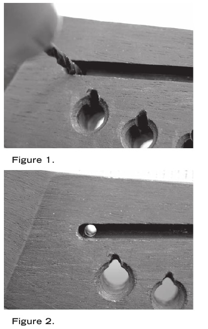 Drill a hole in the saddle slot for the pickup wire